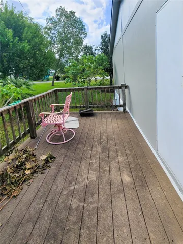 a view of deck with chairs and wooden floor