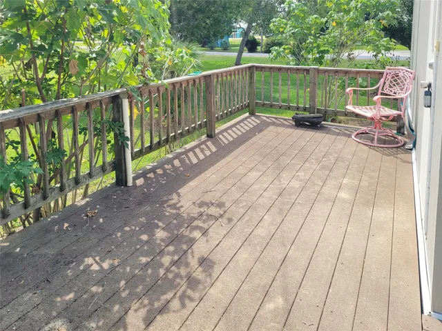 a view of an outdoor space with wooden deck