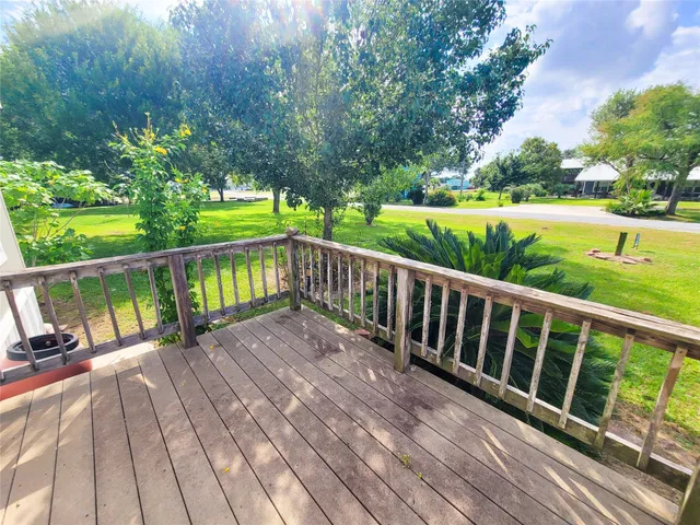 a view of balcony with wooden floor and fence