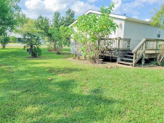 a view of backyard with deck and outdoor seating