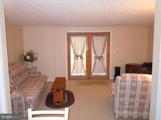 1079 Downton Road Halethorpe, MD 21227 - Photo 14 of 26 a bedroom with furniture and a large window