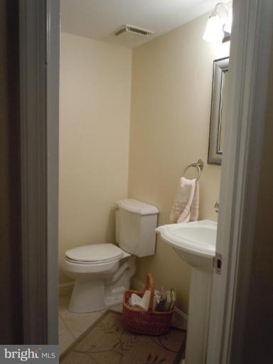 1079 Downton Road Halethorpe, MD 21227 - Photo 16 of 26 a white toilet sitting next to a bathroom sink