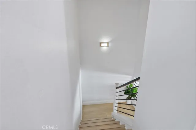 a view of a hallway to closet and a livingroom with furniture