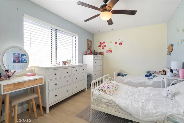 a bedroom with a bed chandelier and a window