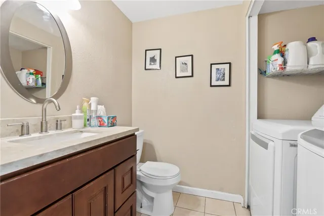 a bathroom with a toilet a sink and a mirror