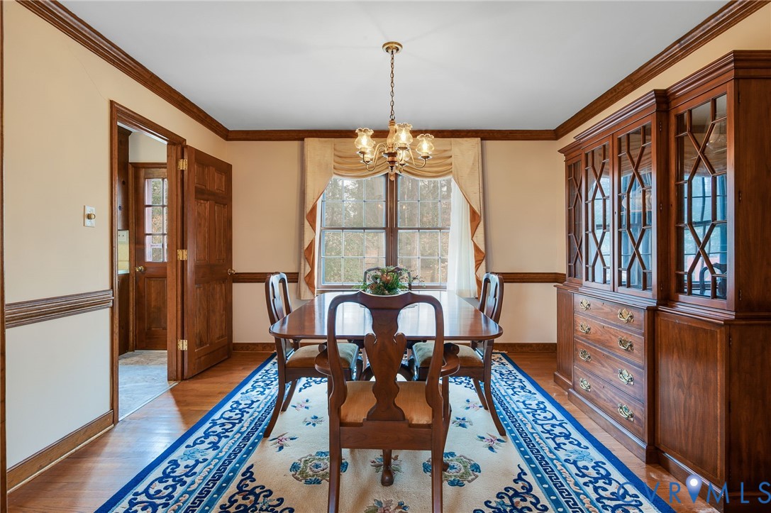 3123 Bradwill Road Richmond, VA 23225 - Photo 16 of 36 Dining space with a chandelier, wood finished floo