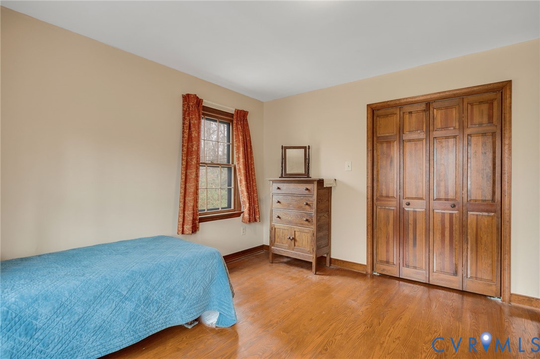 3123 Bradwill Road Richmond, VA 23225 - Photo 27 of 36 Bedroom featuring light wood-style floors and a cl