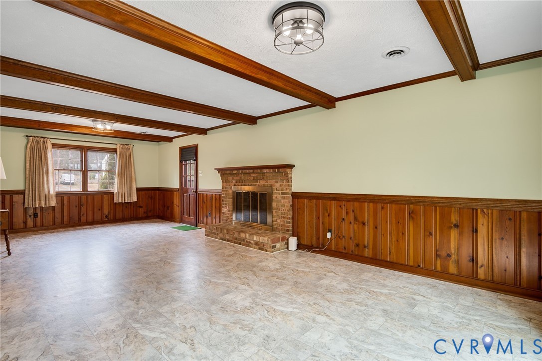 3123 Bradwill Road Richmond, VA 23225 - Photo 31 of 36 Unfurnished living room with wainscoting, a firepl