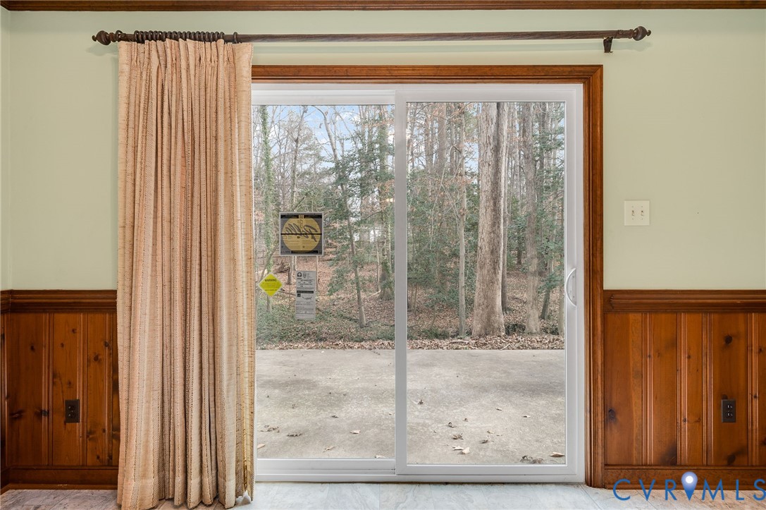 3123 Bradwill Road Richmond, VA 23225 - Photo 32 of 36 Doorway to outside with wainscoting, wood walls, a