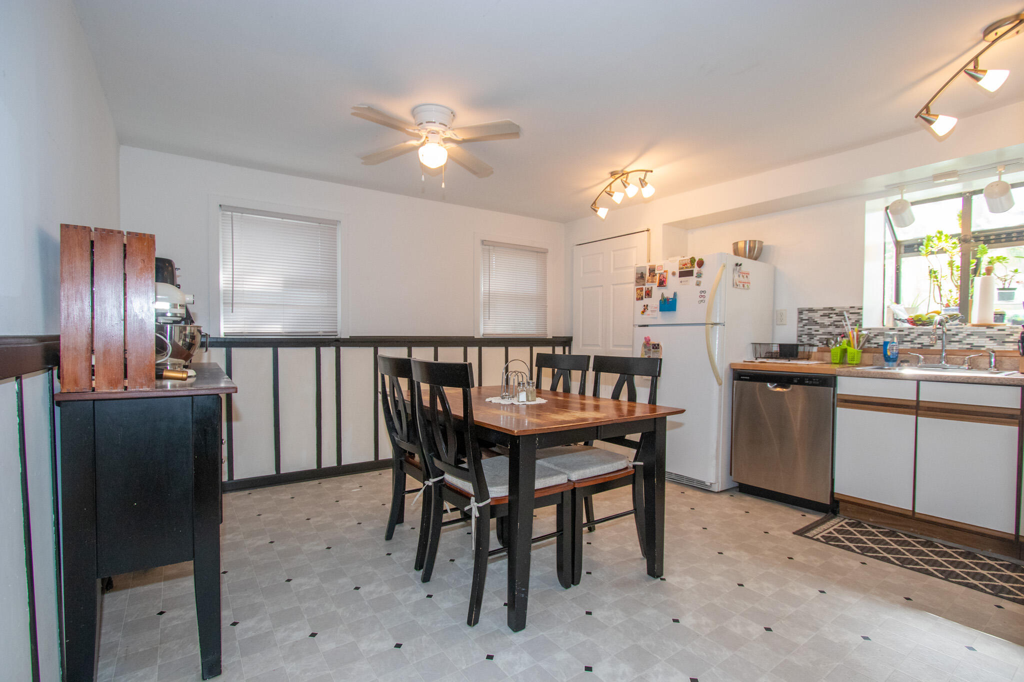 2401 Riverside Drive Lake Station, IN 46405 - Photo 14 of 28 a dining room with wooden floor a chandelier a wooden table and chairs