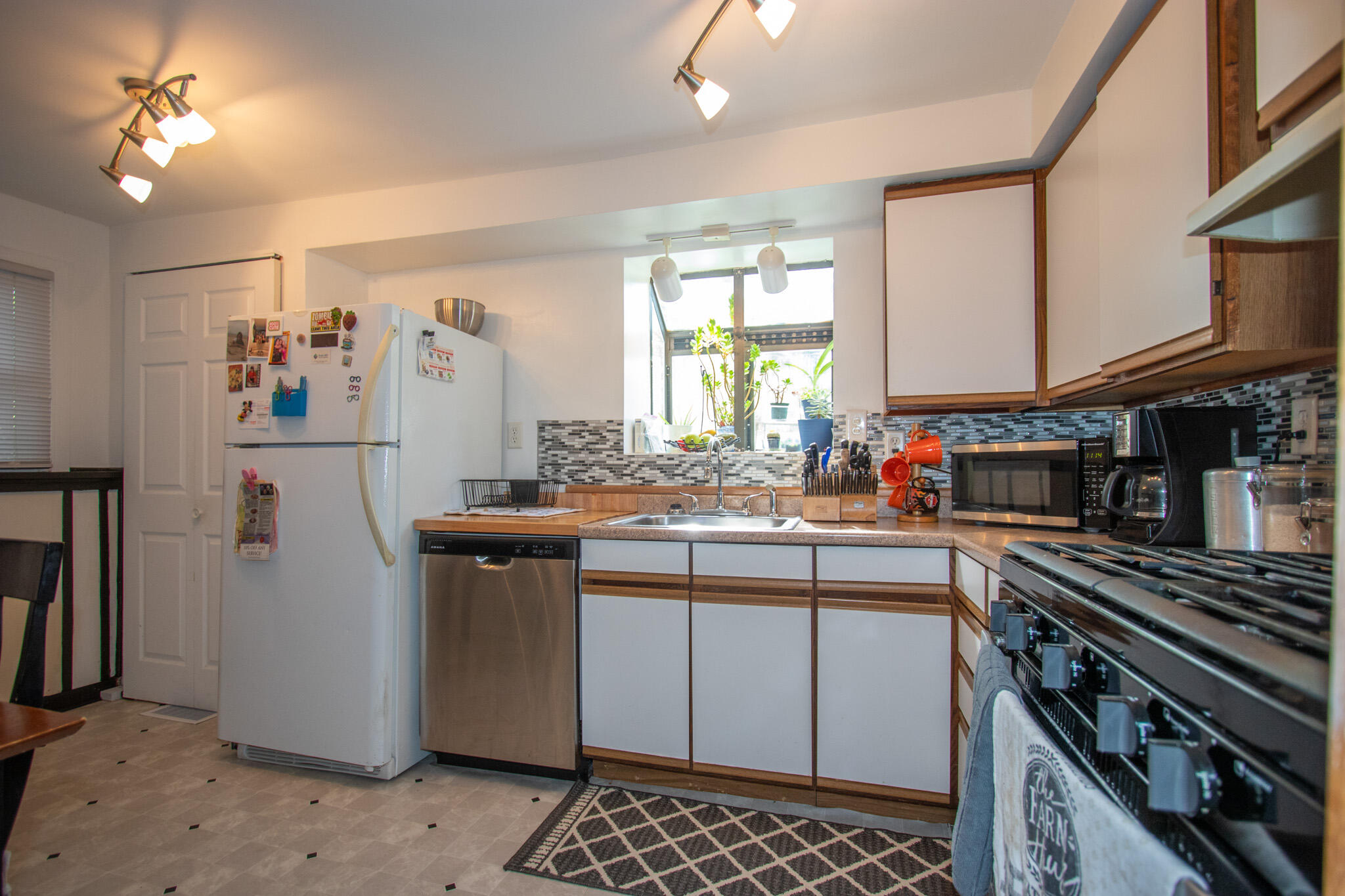 2401 Riverside Drive Lake Station, IN 46405 - Photo 16 of 28 a kitchen with a sink and a stove top oven