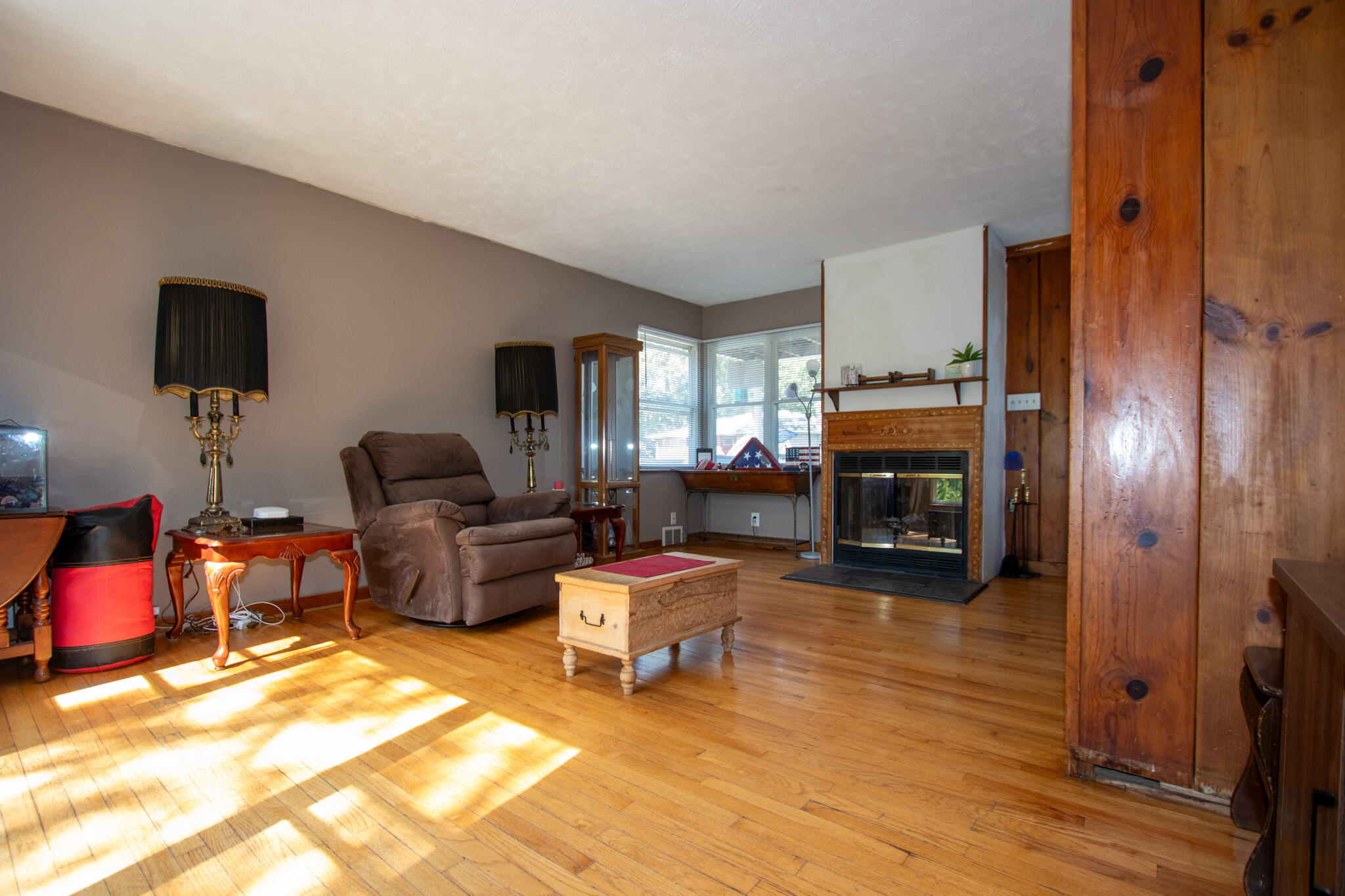 2401 Riverside Drive Lake Station, IN 46405 - Photo 5 of 28 a living room with furniture a fireplace and a flat screen tv