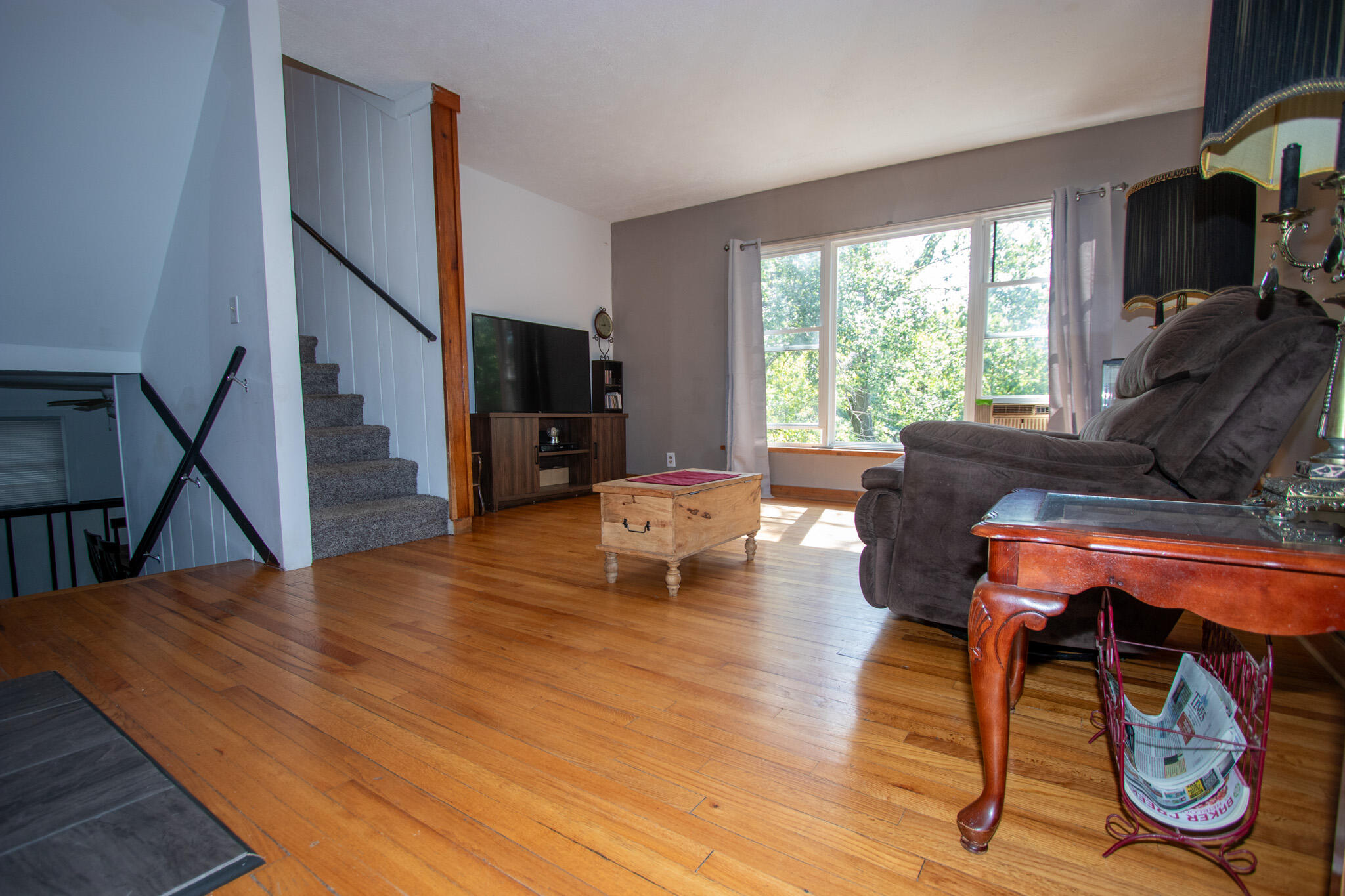 2401 Riverside Drive Lake Station, IN 46405 - Photo 8 of 28 a living room with furniture a flat screen tv and a large window