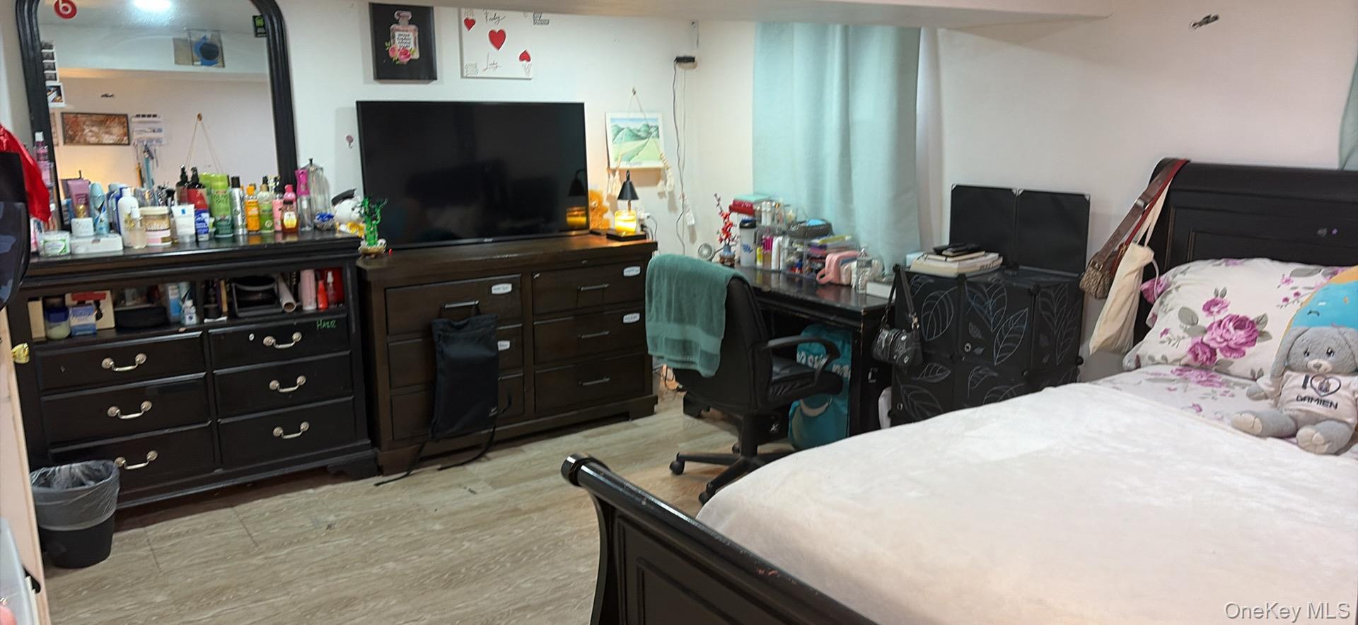 153-12 111th Road Queens, NY 11433 - Photo 14 of 15 a bedroom with a bed and a flat screen tv