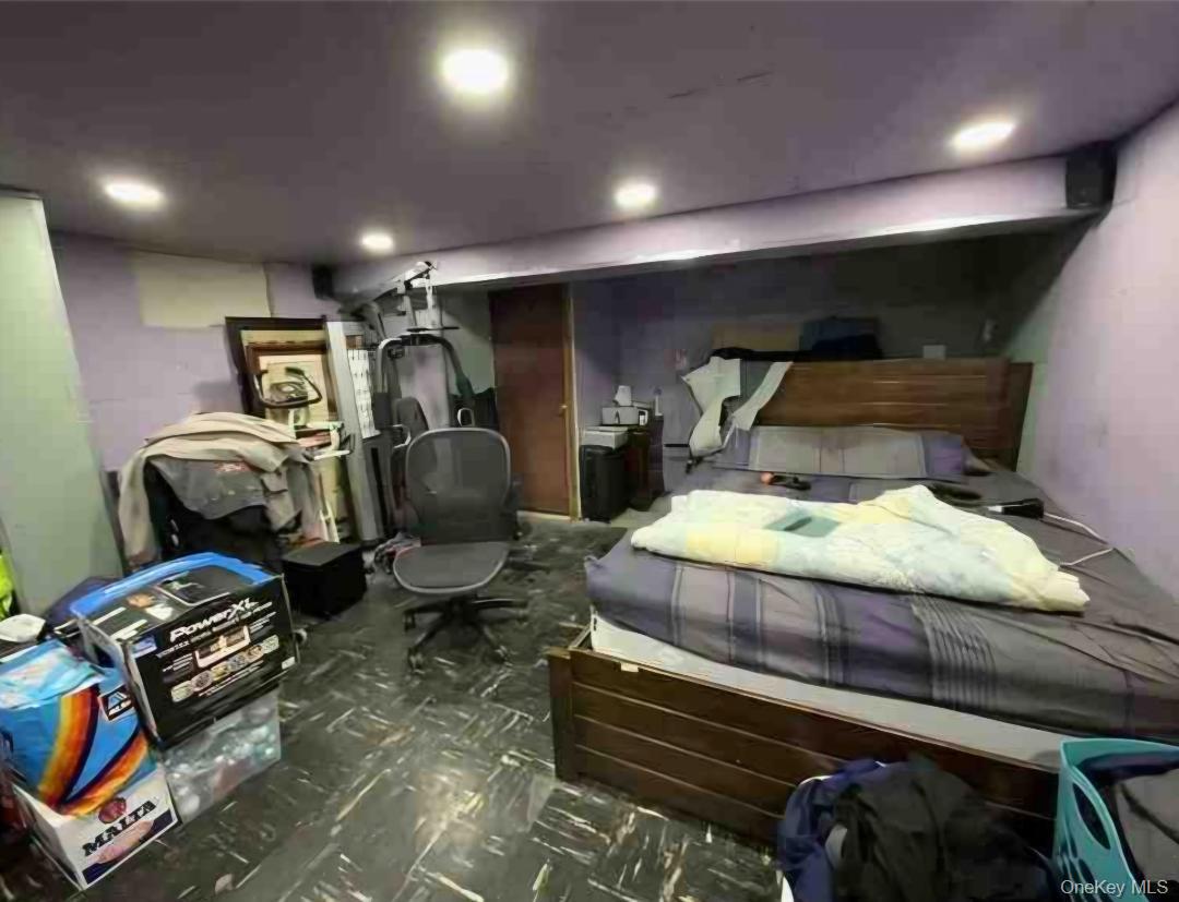 153-12 111th Road Queens, NY 11433 - Photo 2 of 15 a room with gym equipment and a mirror