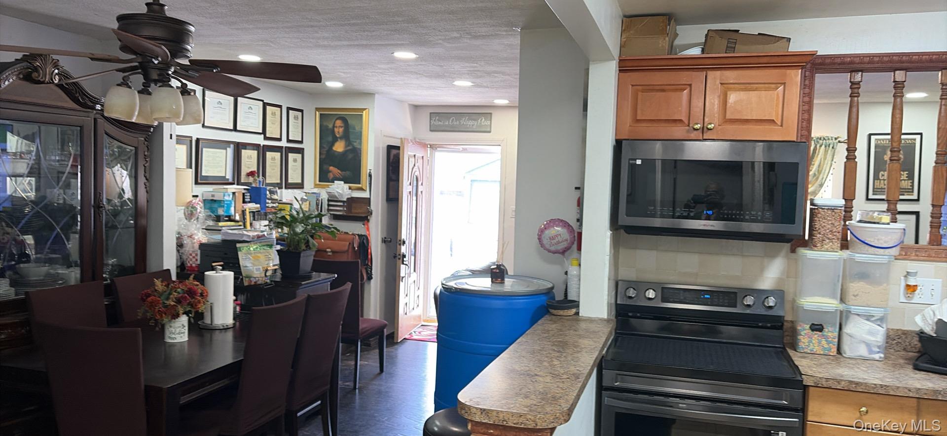 153-12 111th Road Queens, NY 11433 - Photo 8 of 15 a kitchen with a refrigerator and a stove top oven