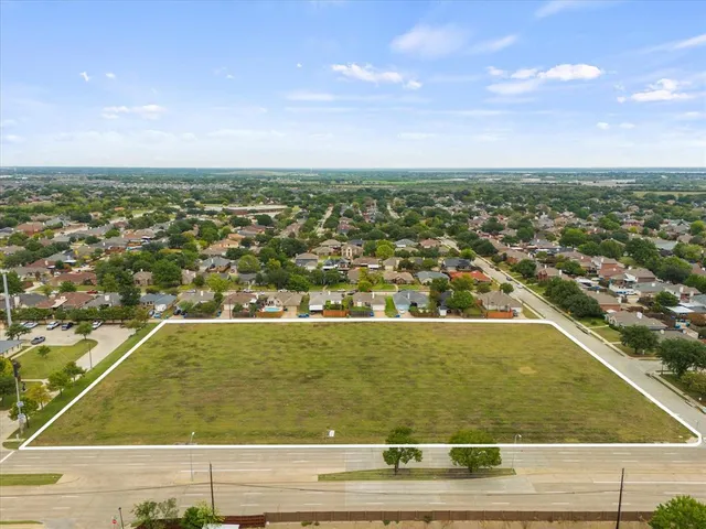 an aerial view of residential houses with city view