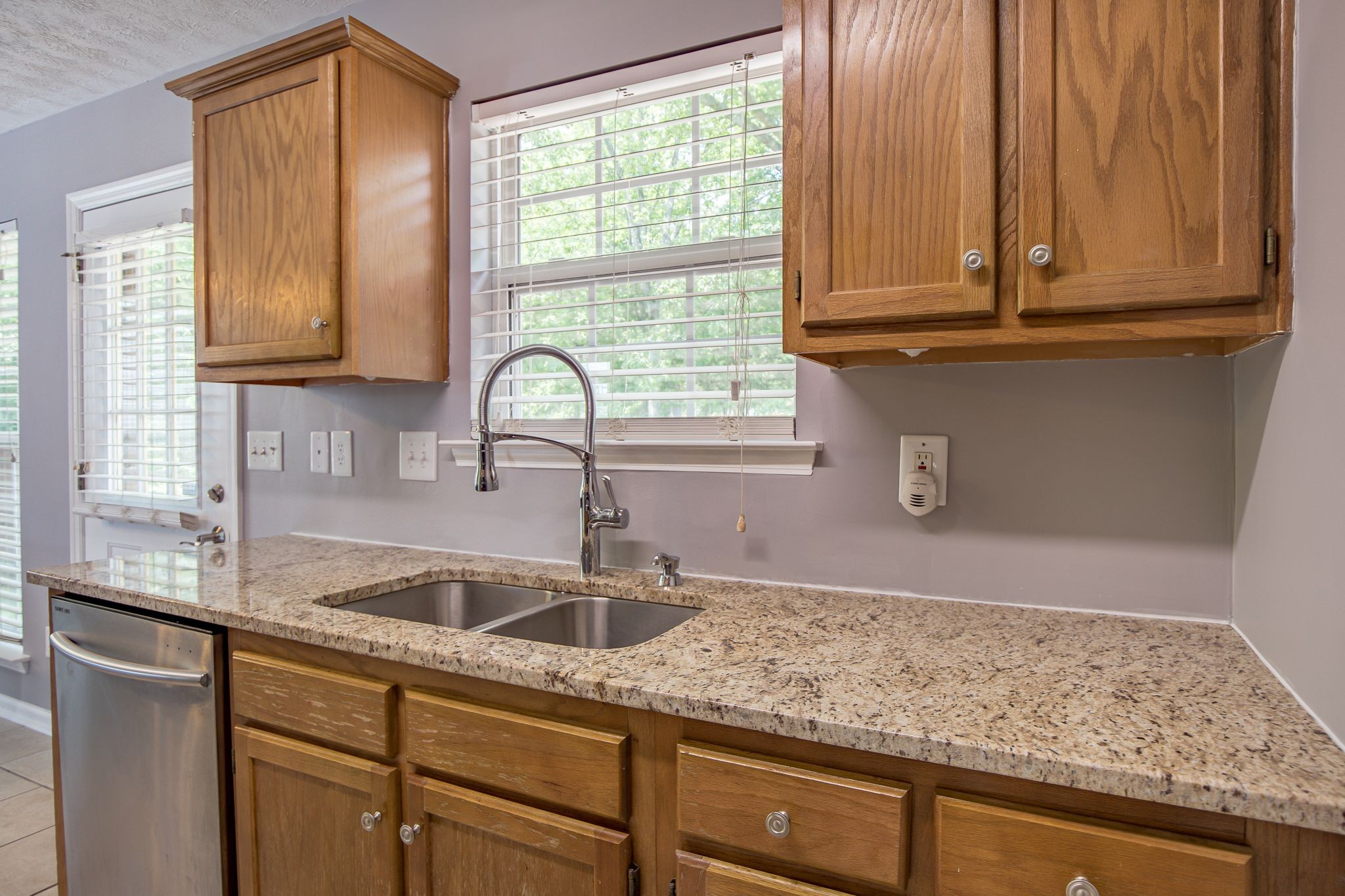 121 Rothwood Court Madison, TN 37115 - Photo 7 of 21 a kitchen with granite countertop a sink and a window