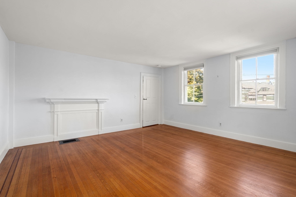 324 Union Street, Unit 1 Millis, MA 02054 - Photo 15 of 29 an empty room with wooden floor and windows