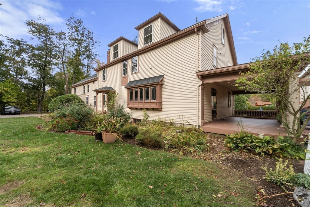 324 Union Street, Unit 1 Millis, MA 02054 - Photo 19 of 29 a front view of a house with garden