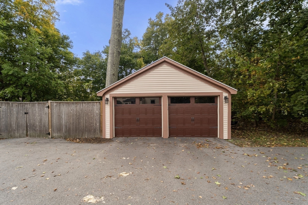 324 Union Street, Unit 1 Millis, MA 02054 - Photo 22 of 29 a front view of house with yard and trees in the background