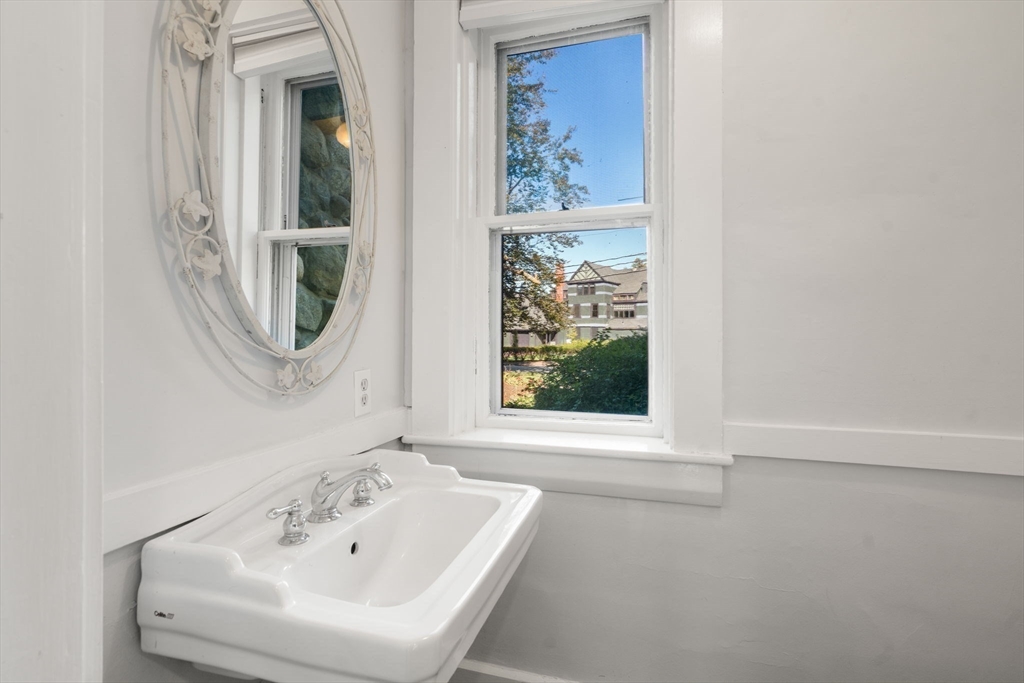 324 Union Street, Unit 1 Millis, MA 02054 - Photo 10 of 29 a bathroom with a sink a mirror and a window