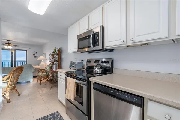 a kitchen with stainless steel appliances granite countertop a sink stove and microwave