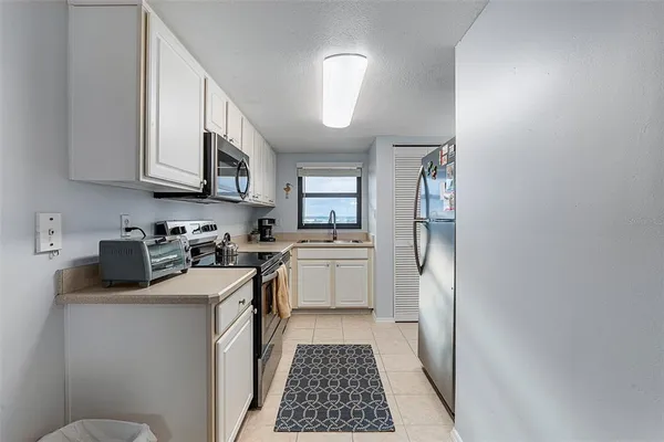 a kitchen with a sink cabinets and stainless steel appliances