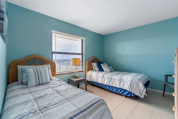 a bedroom with two beds and a window