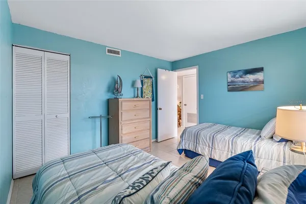 a bedroom with a bed and a painting on the wall