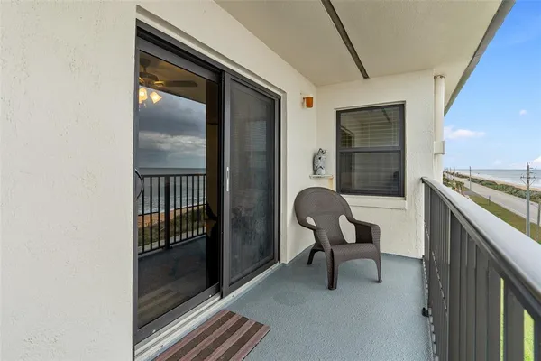 a view of a hallway with furniture and front door