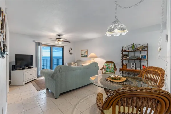 a living room with furniture a chandelier and a flat screen tv