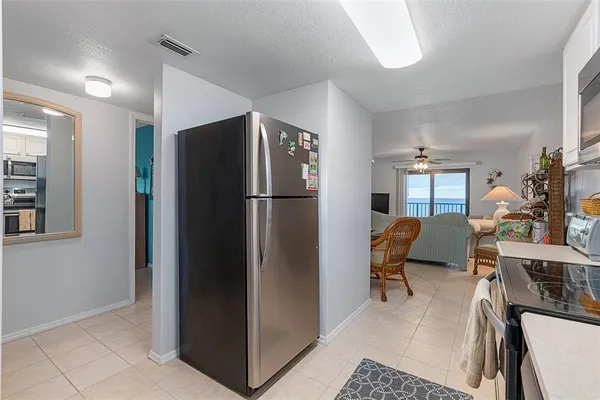 a kitchen with stainless steel appliances a refrigerator and a refrigerator