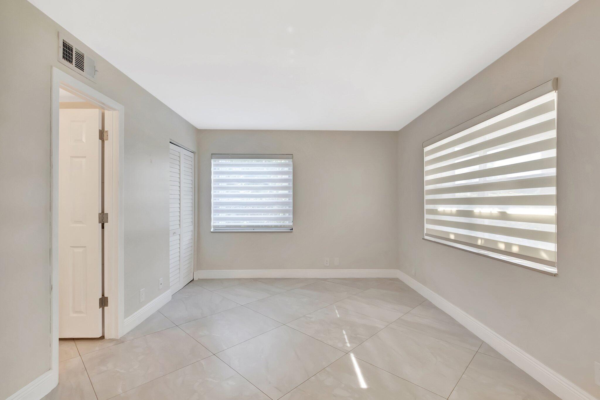 1131 Violet Terrace, Unit 104 Delray Beach, FL 33445 - Photo 16 of 36 a view of an empty room with a window