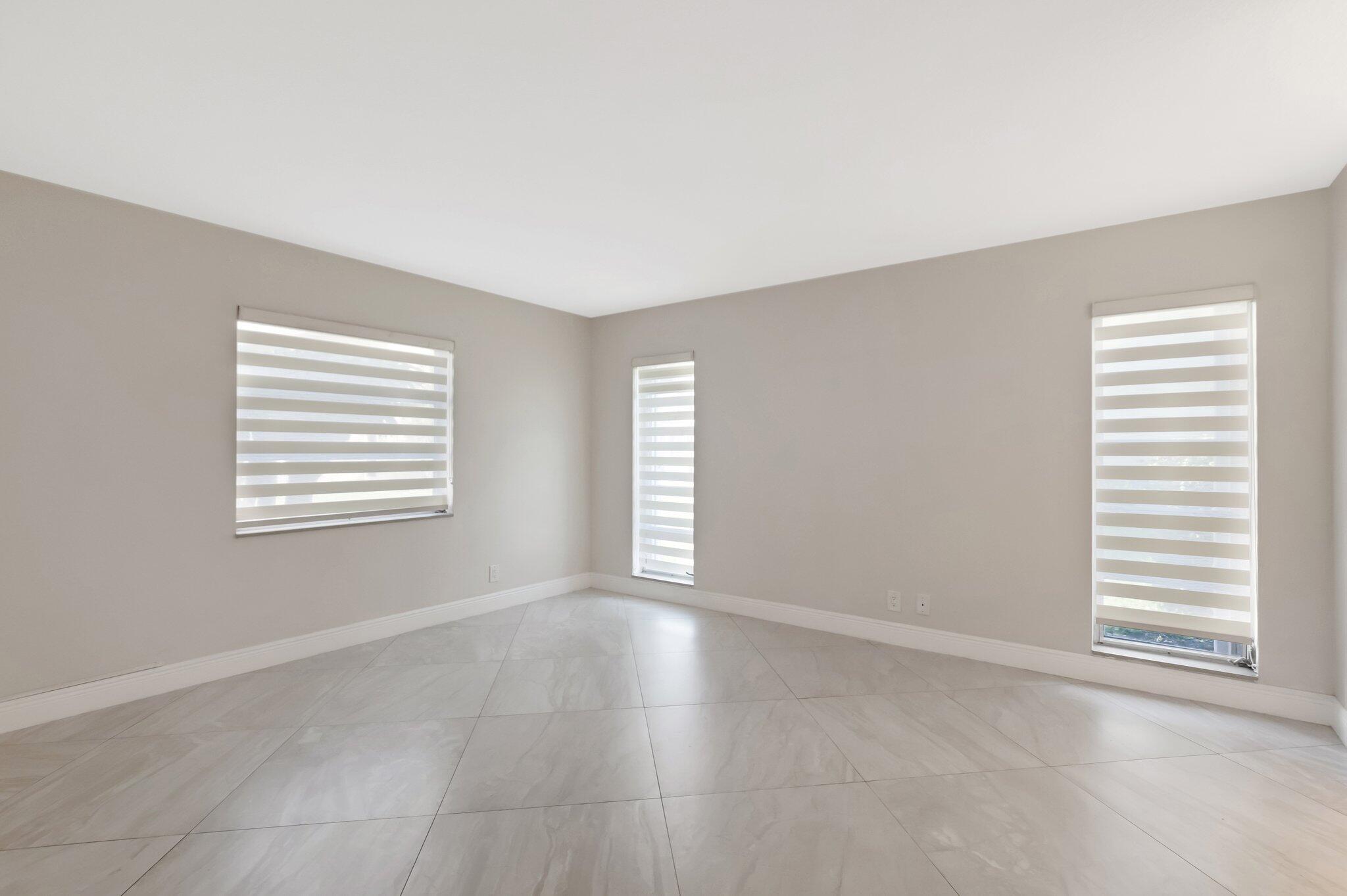 1131 Violet Terrace, Unit 104 Delray Beach, FL 33445 - Photo 20 of 36 a view of an empty room with a window