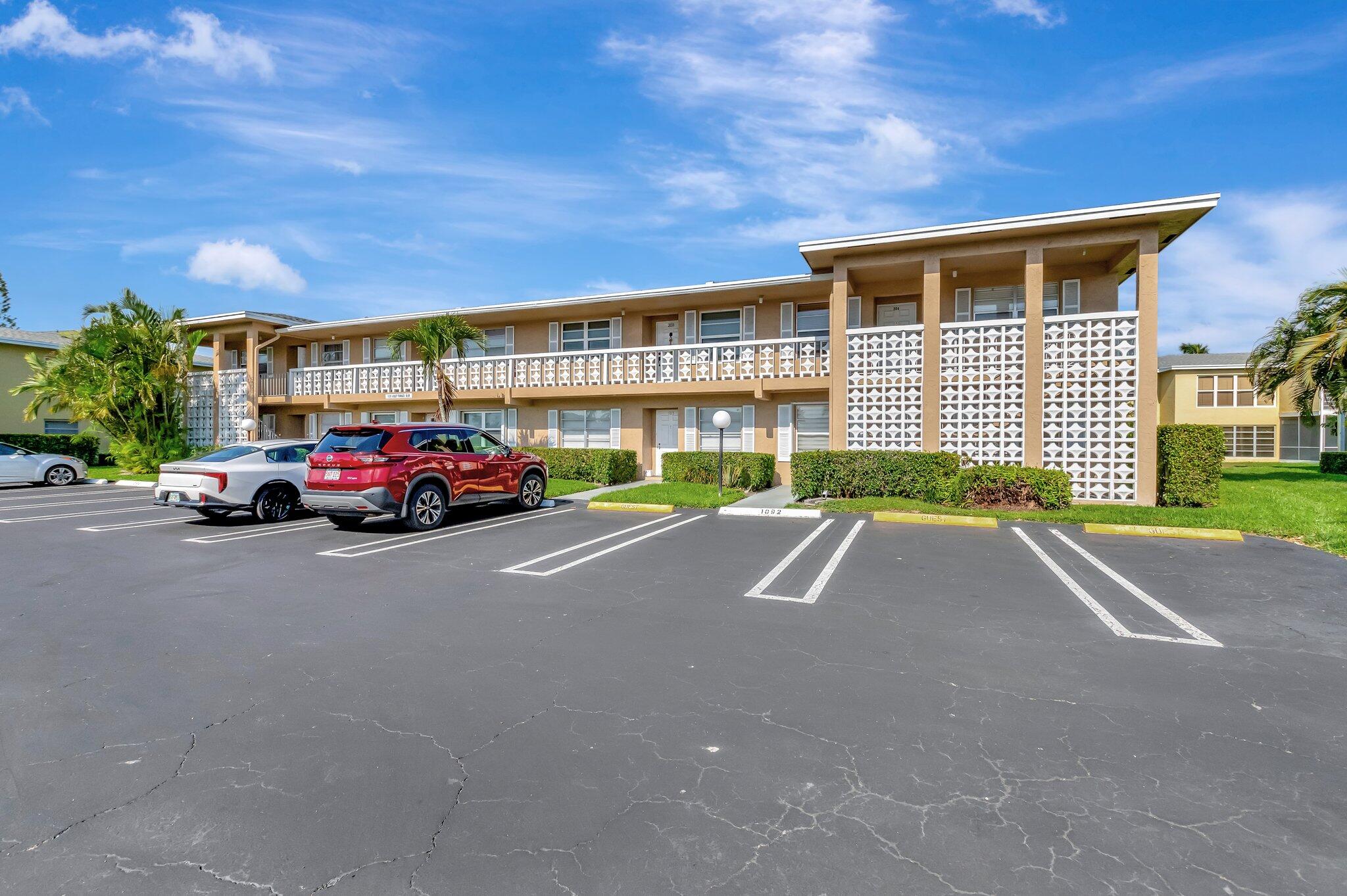 1131 Violet Terrace, Unit 104 Delray Beach, FL 33445 - Photo 2 of 36 a car parked in front of a building