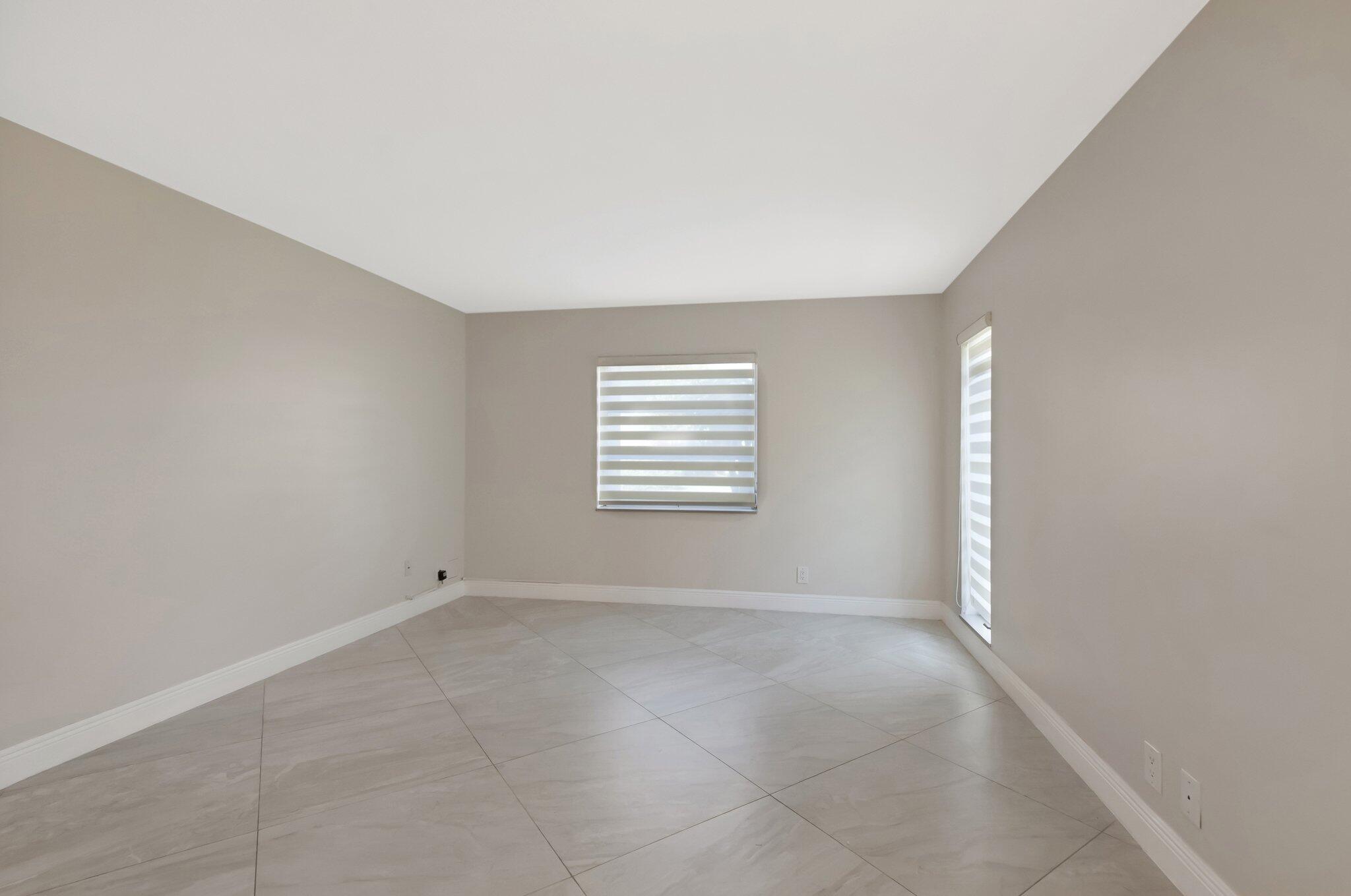 1131 Violet Terrace, Unit 104 Delray Beach, FL 33445 - Photo 21 of 36 a view of an empty room with a window
