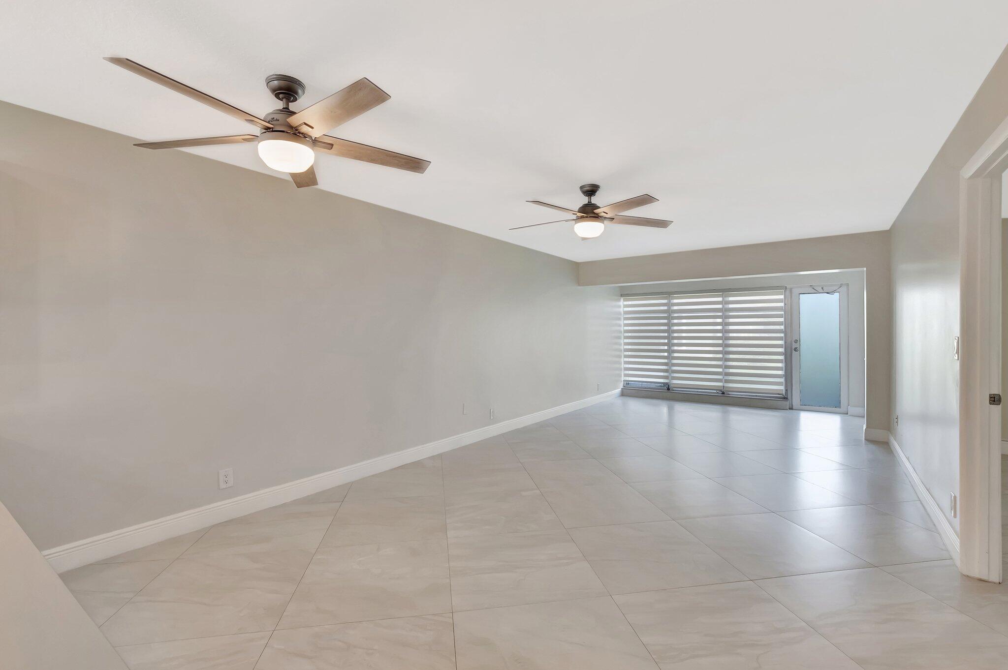 1131 Violet Terrace, Unit 104 Delray Beach, FL 33445 - Photo 5 of 36 a view of an empty room with a window