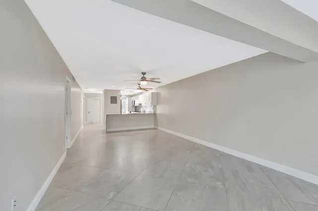 an empty room with windows and entrance