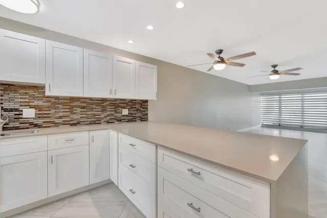 a kitchen with a sink a stove and refrigerator