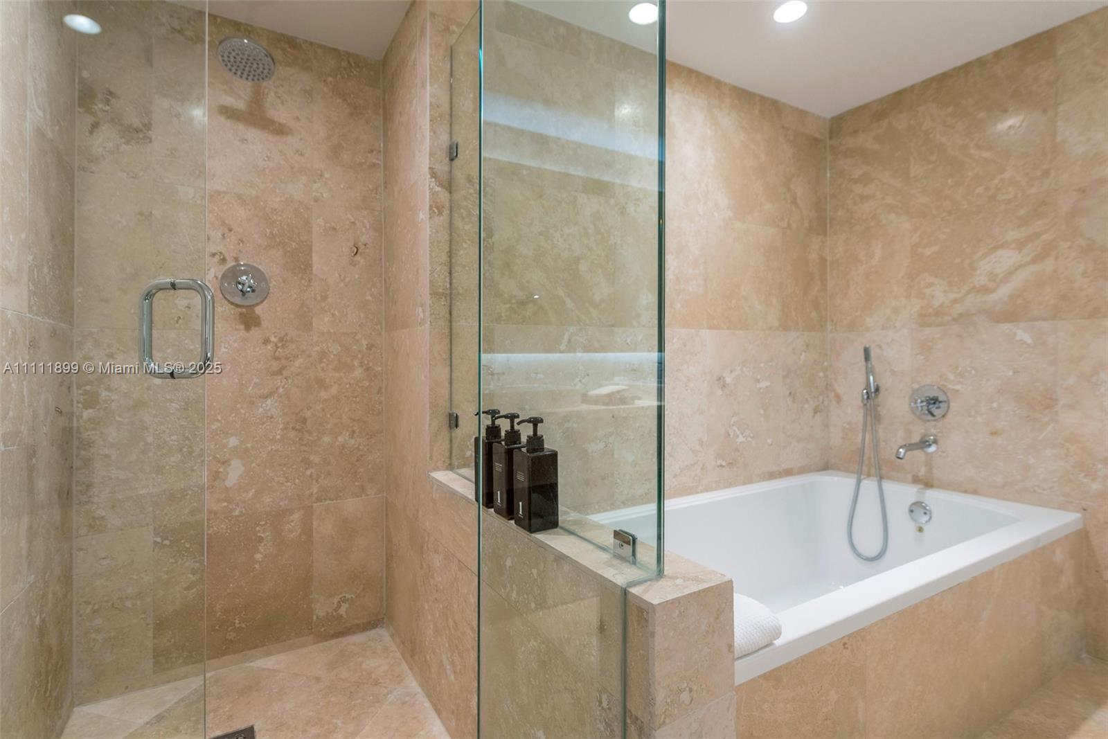 102 24th Street, Unit 1015 Miami Beach, FL 33139 - Photo 13 of 20 a bathroom with a bathtub and shower
