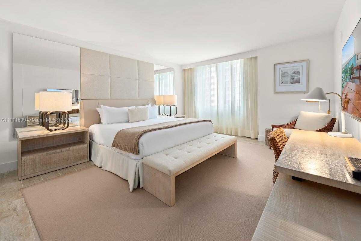 102 24th Street, Unit 1015 Miami Beach, FL 33139 - Photo 3 of 20 a bedroom with a bed and a couch