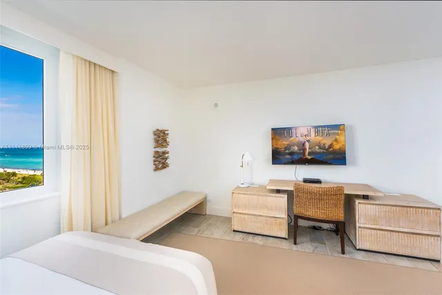 a bedroom with furniture and a flat screen tv