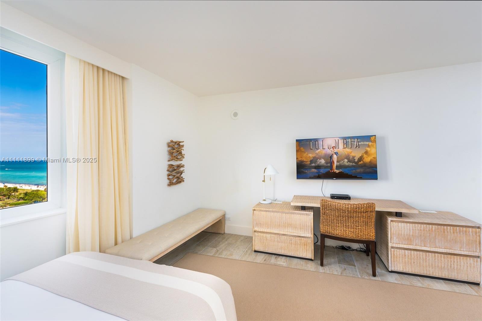 102 24th Street, Unit 1015 Miami Beach, FL 33139 - Photo 7 of 20 a bedroom with furniture and a flat screen tv