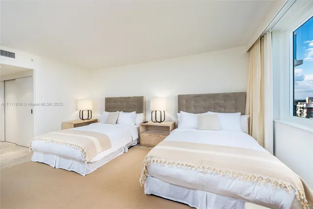 a bedroom with bed and a night stand