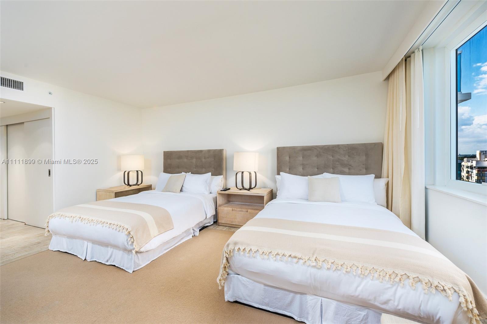 102 24th Street, Unit 1015 Miami Beach, FL 33139 - Photo 8 of 20 a bedroom with bed and a night stand