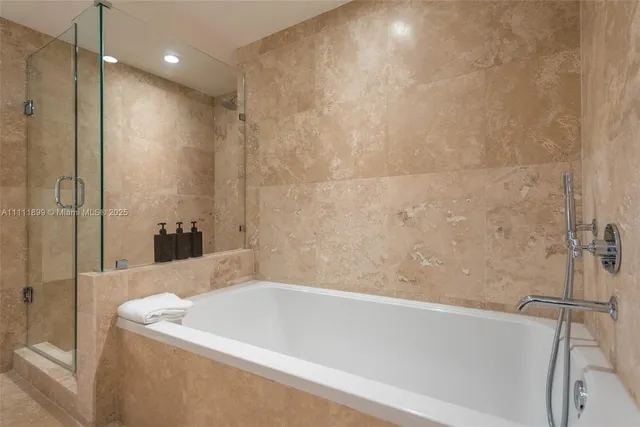 a bathroom with a bathtub and a shower