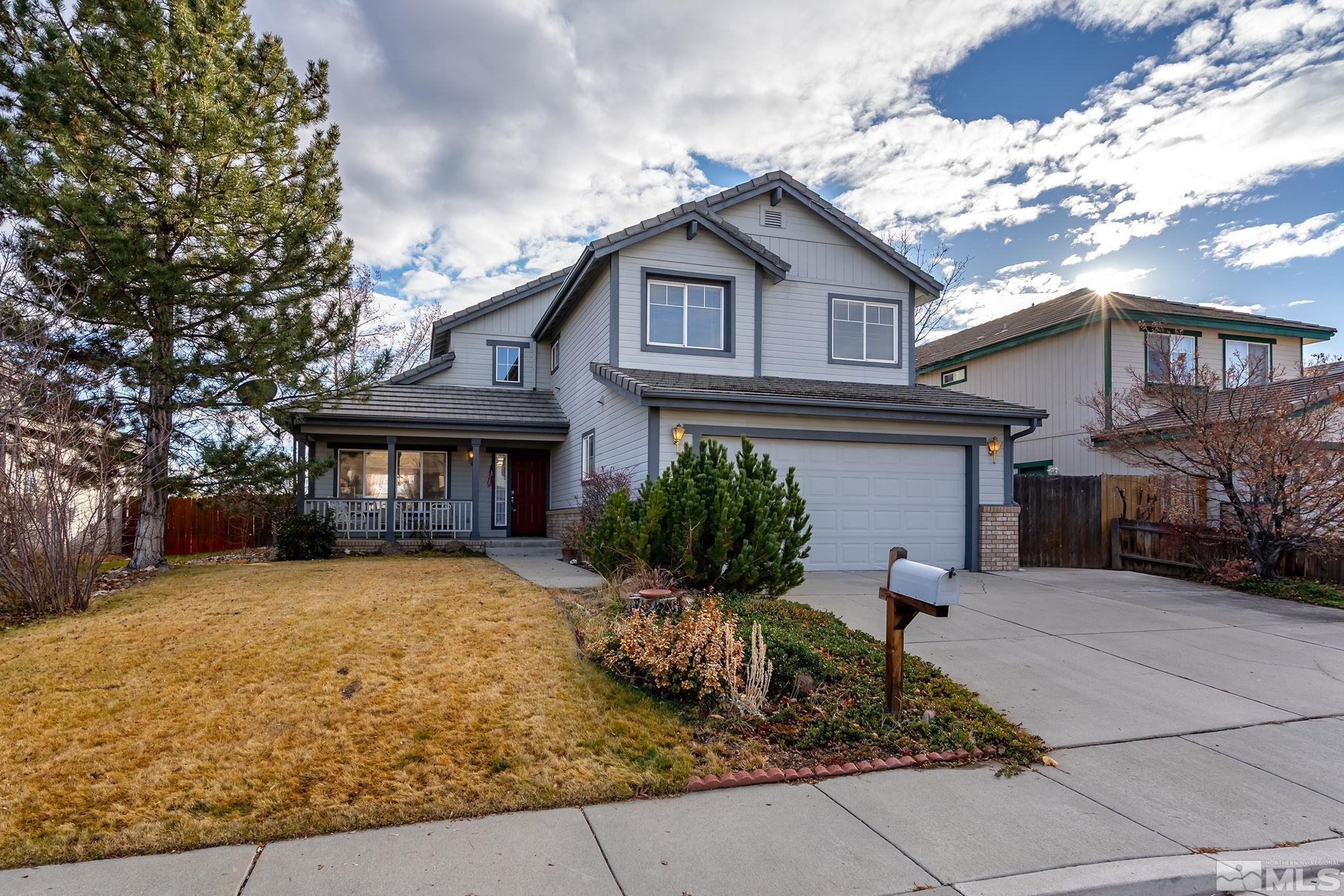 a front view of a house with a yard outdoor seating and garage