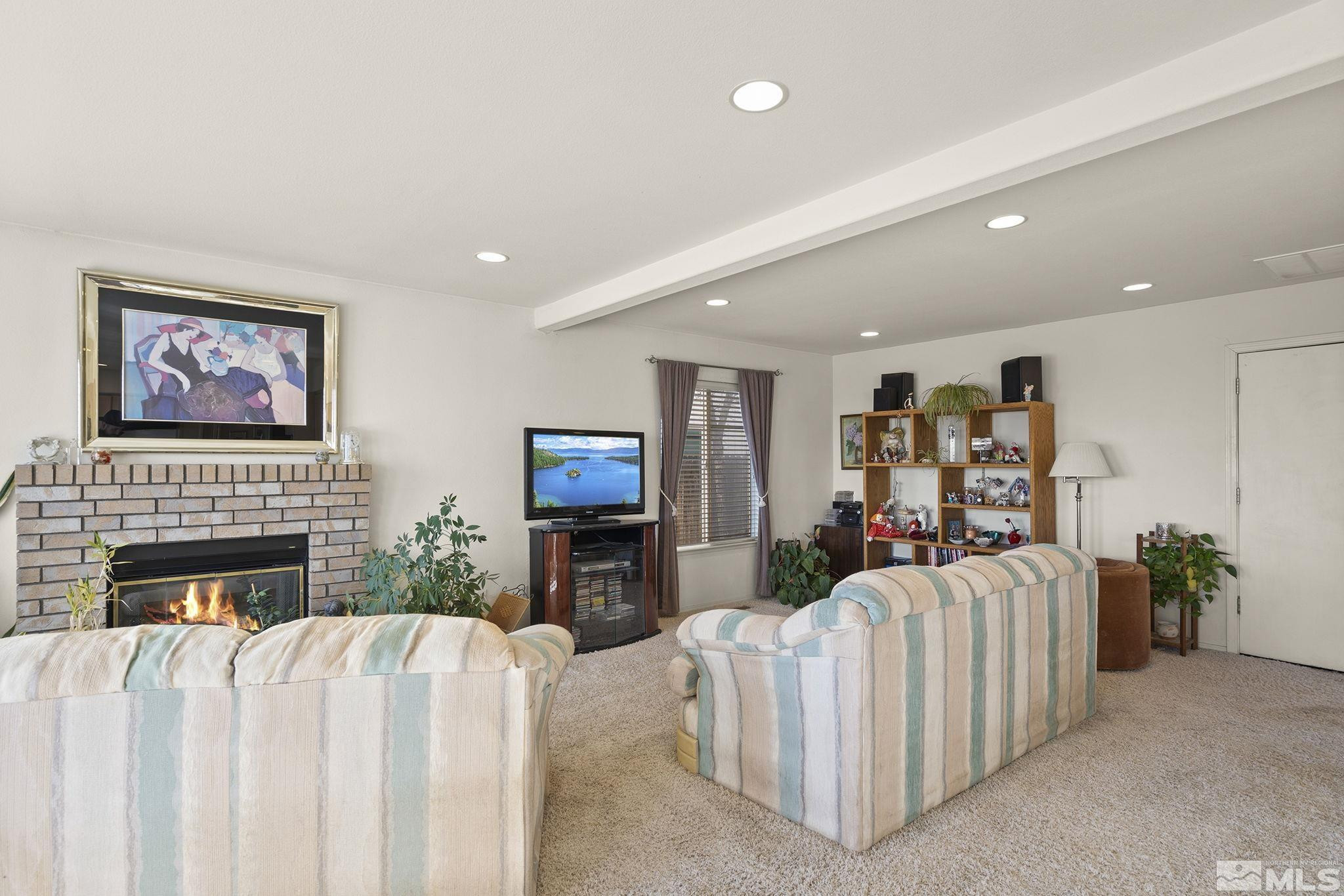 5364 Tappan Court Reno, NV 89523 - Photo 12 of 40 a living room with furniture a flat screen tv and a fireplace