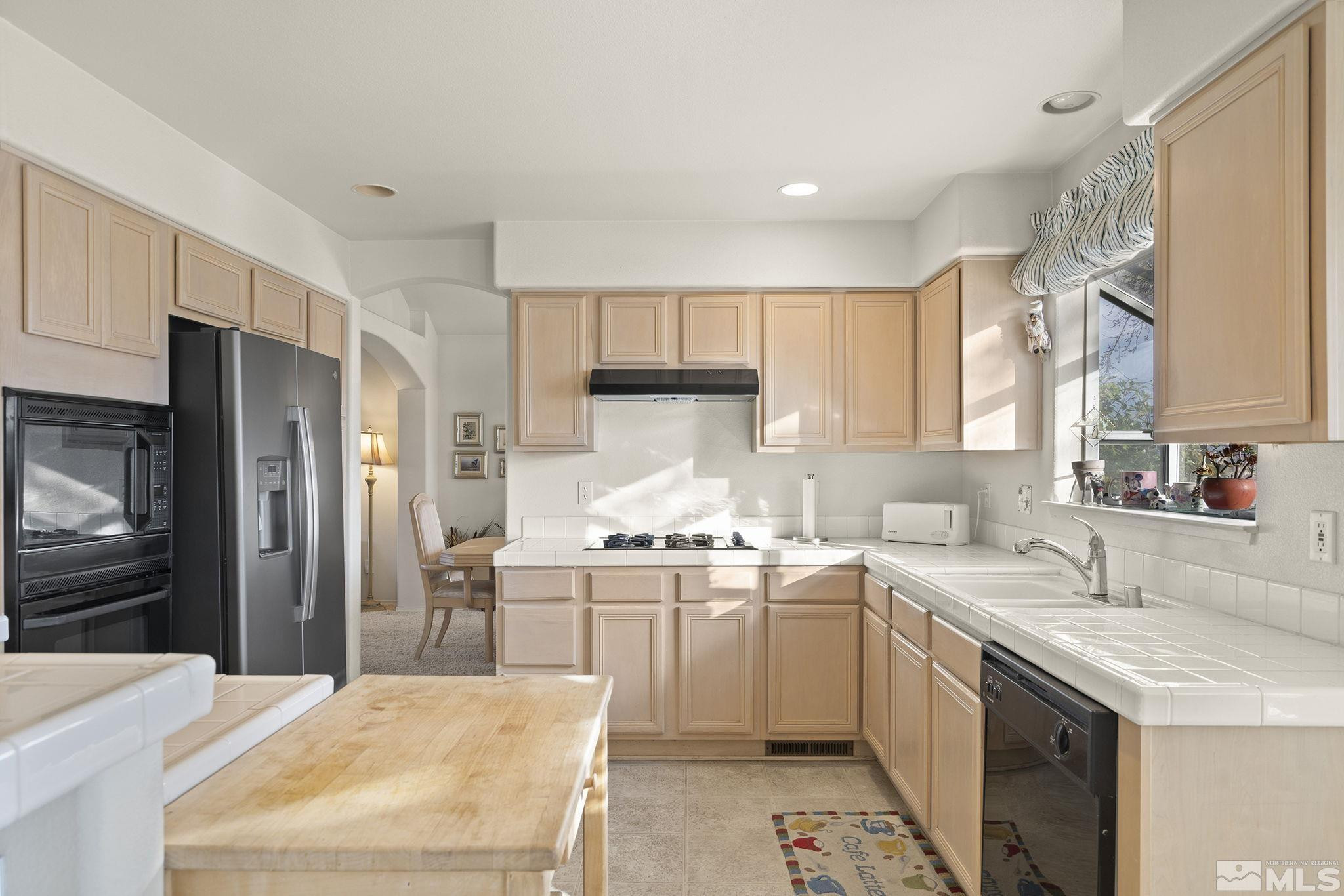 5364 Tappan Court Reno, NV 89523 - Photo 16 of 40 a kitchen with a sink stove and refrigerator